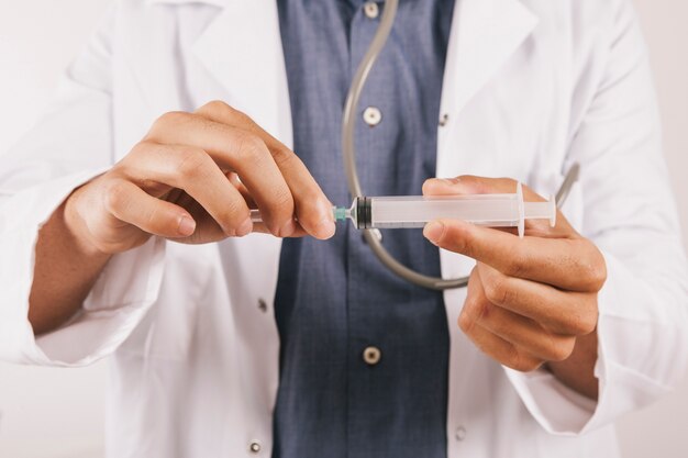 Doctor's hand holding a vaccine