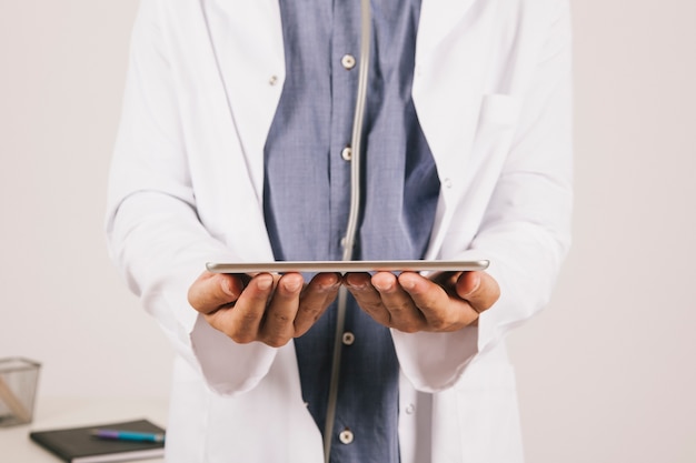 Doctor's hands holding ipad