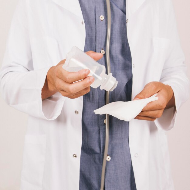 Doctor's hands with alcohola and gauze