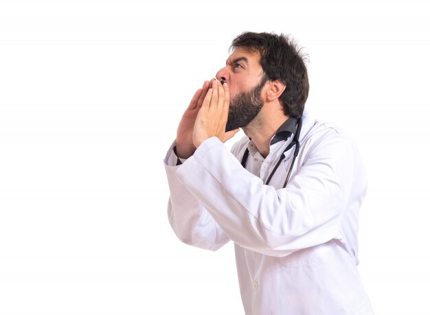 Doctor shouting over isolated white background