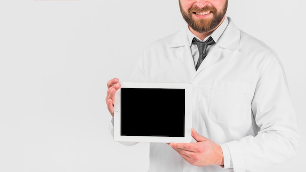 Doctor showing tablet and smiling