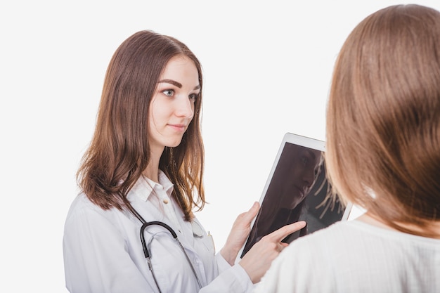 Doctor showing tablet to woman