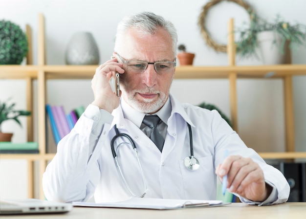 Doctor speaking on phone in office