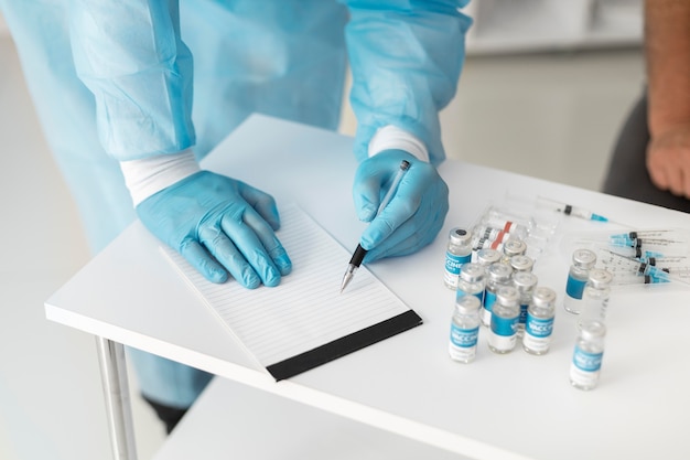 Doctor in special equipment getting ready to vaccinate a patient