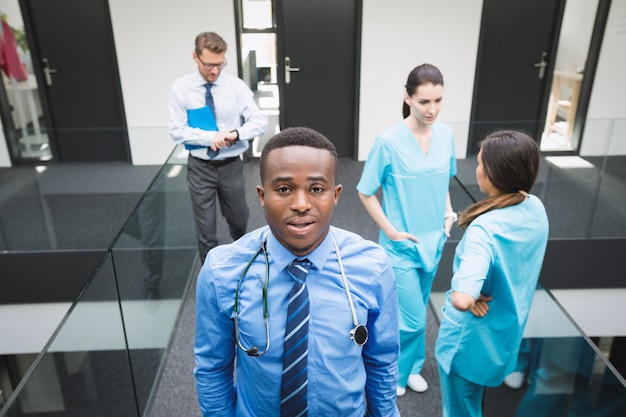 Free photo doctor standing in hospital corridor