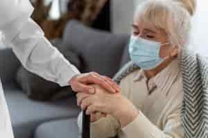 Free photo doctor taking care of senior woman