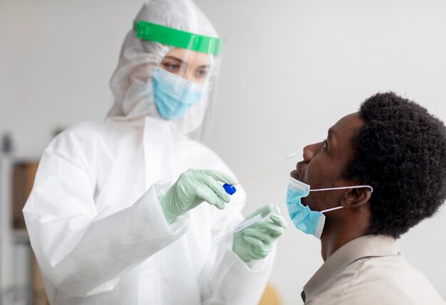 Доктор берет образец теста на коронавирус