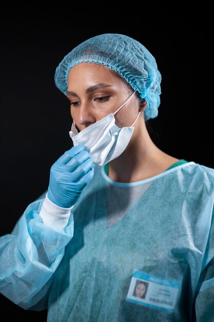 Free photo doctor taking off face mask medium shot