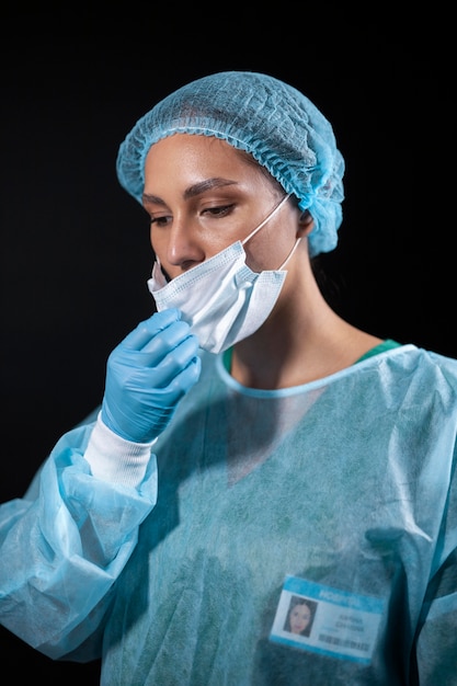 Doctor taking off face mask medium shot