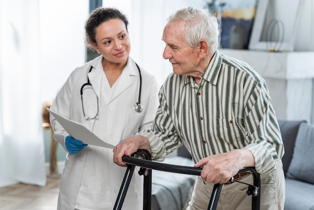 Free photo doctor talking to senior man indoors