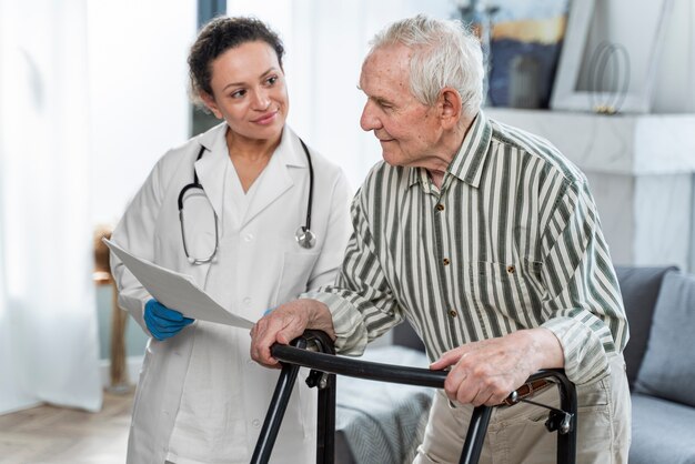 Doctor talking to senior man indoors