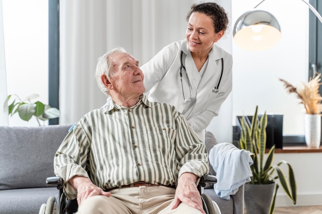 Doctor talking to senior man indoors