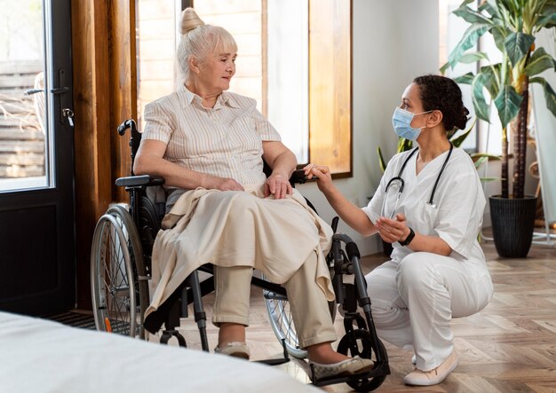 Doctor talking with her elder patient