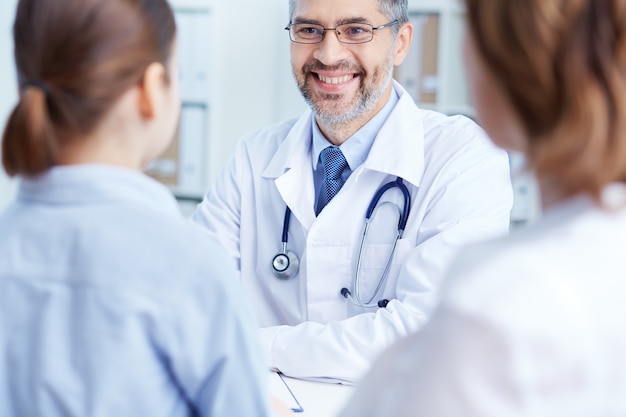 Doctor talking with patients