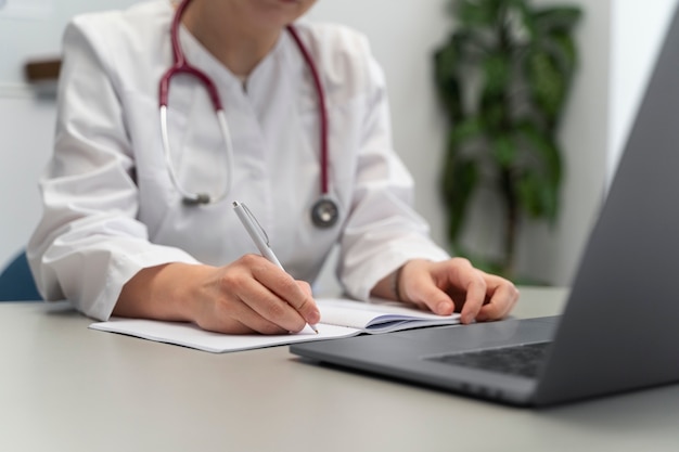 Doctor teleconsulting patient on laptop