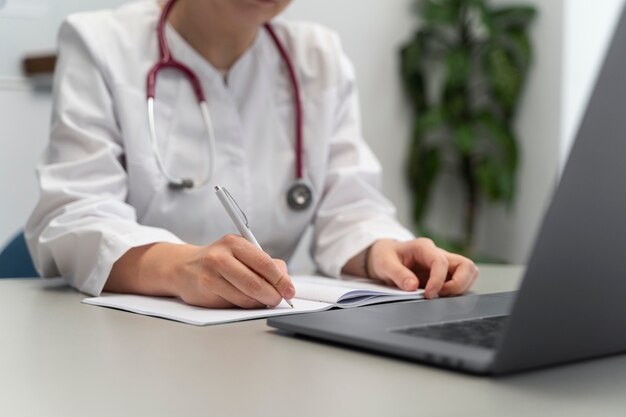 Doctor teleconsulting patient on laptop