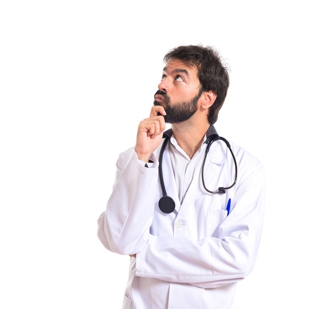 Doctor thinking over isolated white background