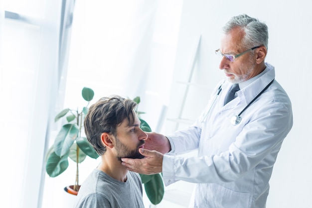 Doctor touching lymph nodes of patient