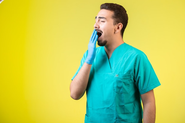 Doctor in uniform and hand mask is tired and snoring.