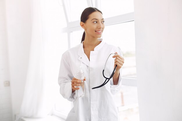 Doctor in a uniform standing on white