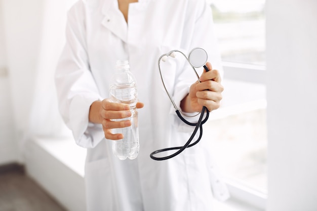 Doctor in a uniform standing on white