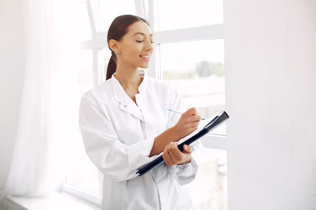 Doctor in a uniform standing on white