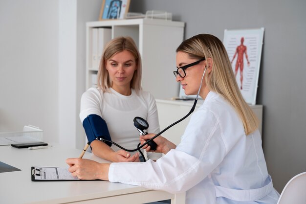 Doctor using mechanical tensiometer medium shot