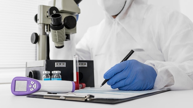 Doctor using a microscope to check covid sample