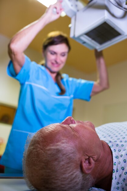 Doctor using x-ray machine to examine patient