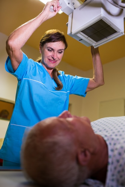 Doctor using x-ray machine to examine patient