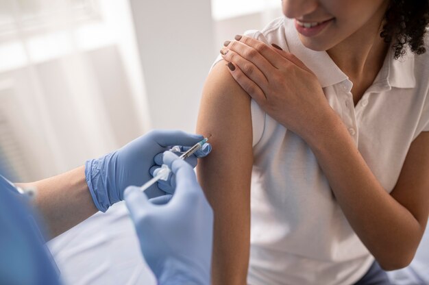 Doctor vaccinating a patient in a clinic