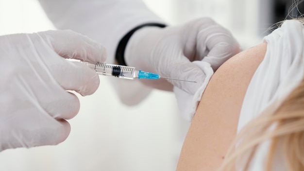 Doctor vaccinating a patient in the clinic