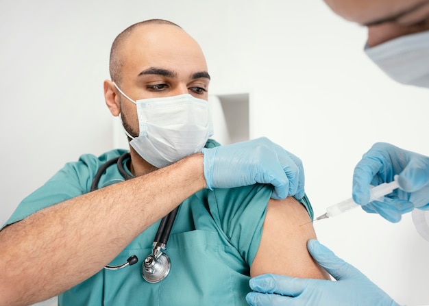 Doctor vaccinating a patient in the clinic