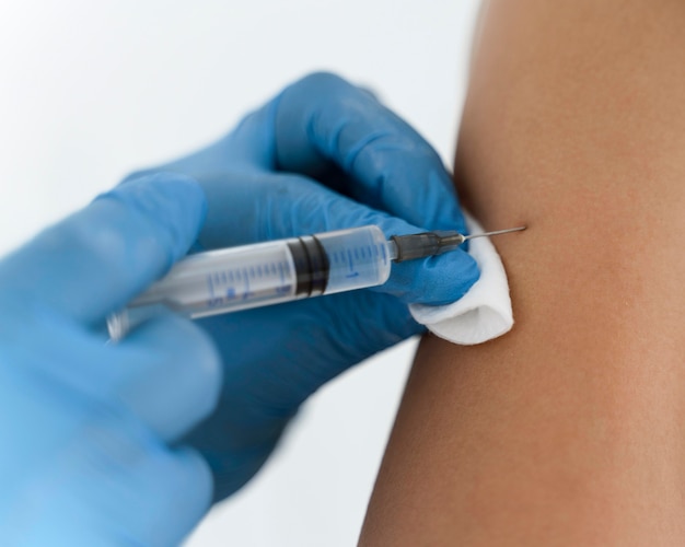 doctor vaccinating a patient close-up