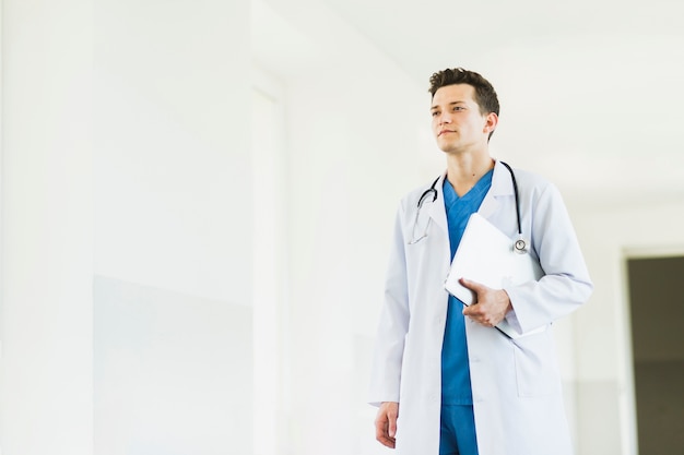 Doctor walking with clipboard