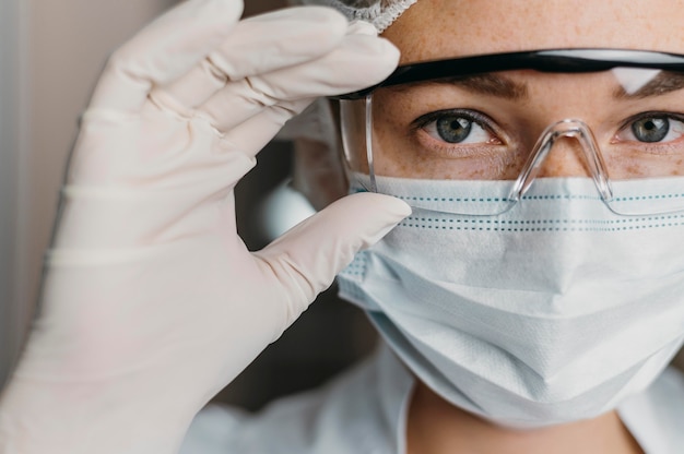 Doctor wearing a face mask and protective goggles