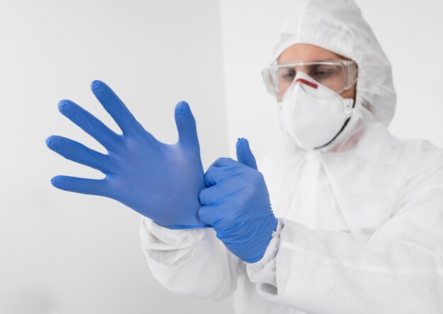 Doctor wearing a face mask and surgical gloves