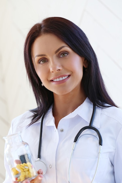 Free photo doctor wearing white robe and stethoscope