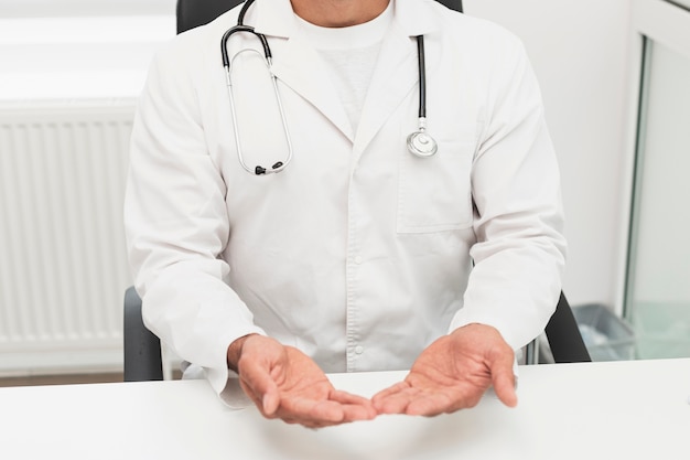 Doctor in white robe showing his hands