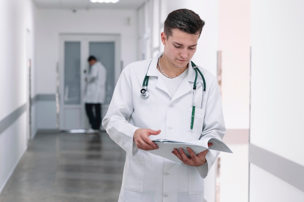 Doctor with documents in hall