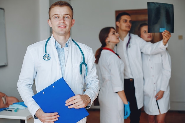 Doctor with a folder in his hands looks at the camera