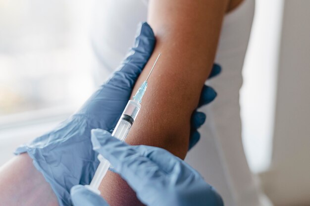 子供にワクチンを与える手袋をした医師