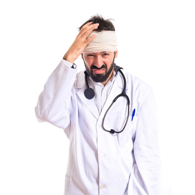 Doctor with headache over white background