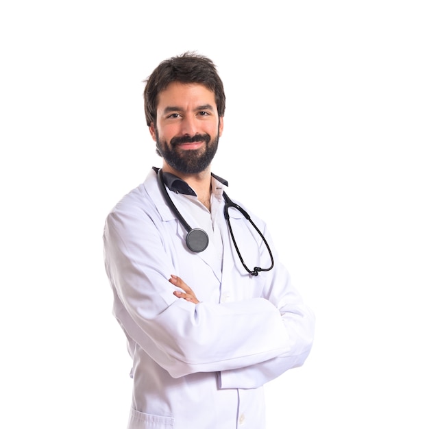 Doctor with his arms crossed over white background