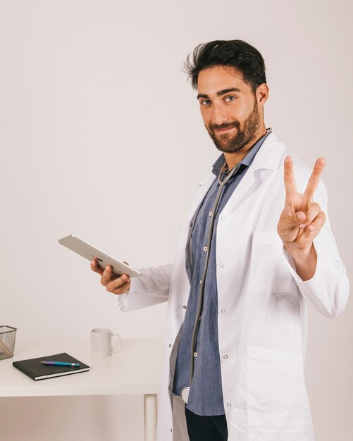 Doctor With Ipad Showing Two Fingers