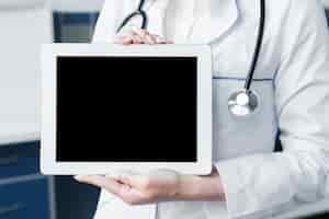 Free photo doctor with a stethoscope and a tablet