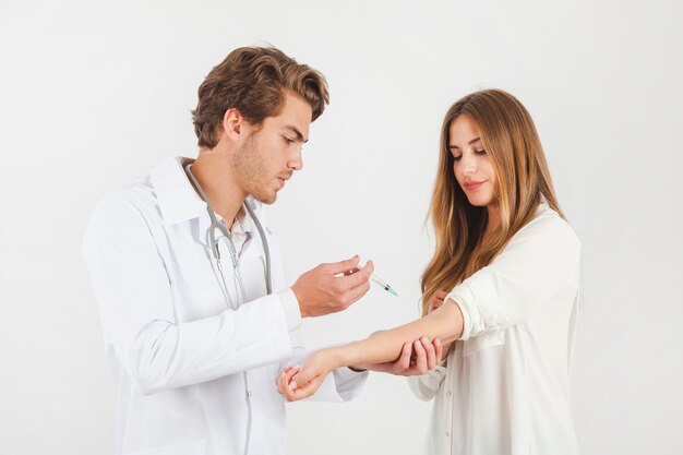 Doctor with syringe and patient