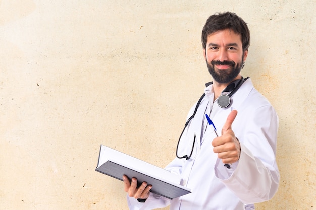 Doctor with thumb up over white background