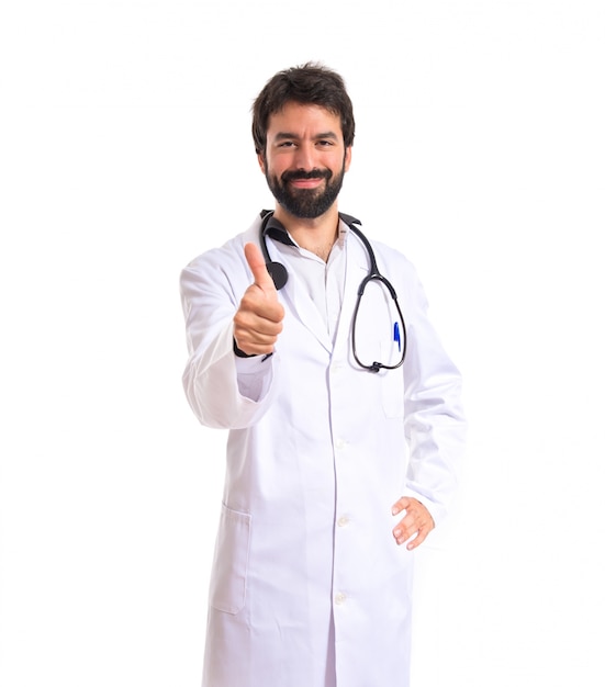 Doctor with thumbs up over white background