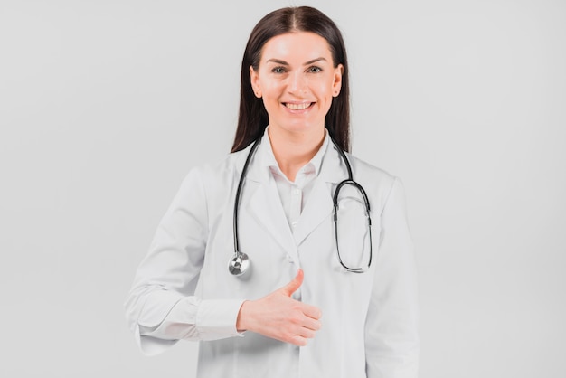 Doctor woman smiling and gesturing thumbs up